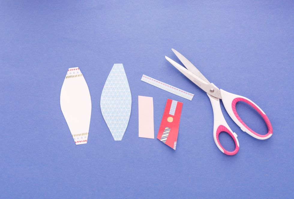 Now that we\u2019ve graduated from Cutting Cards 101, we\u2019re going to get a tad more advanced and make a paper bow. Cut out two pointed oval shapes, two rectangle shapes and one skinny strip.