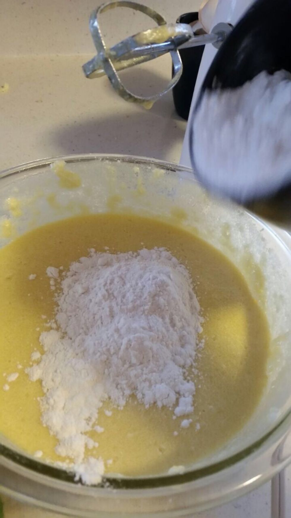 Now that you have the flour, mix it with the other mix of butter, sugar, eggs, and vanilla extract. Put the flour/baking powder in using small amounts at a time.