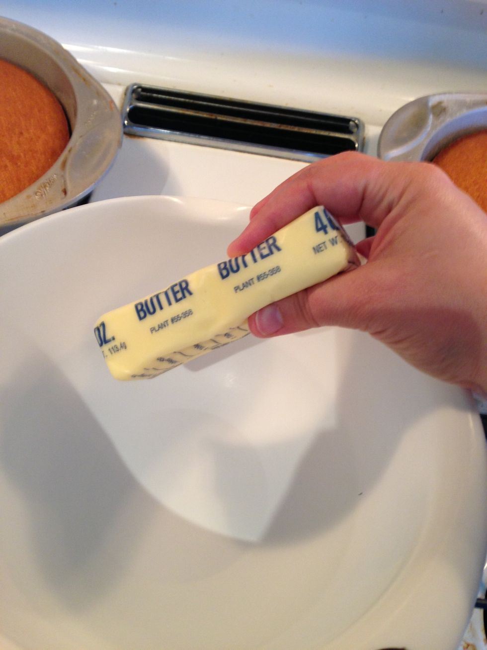 Now that your cake pans are made and cooled, it is time to start your Cream Cheese frosting! Add your softened 1 stick of butter to a medium size bowl.