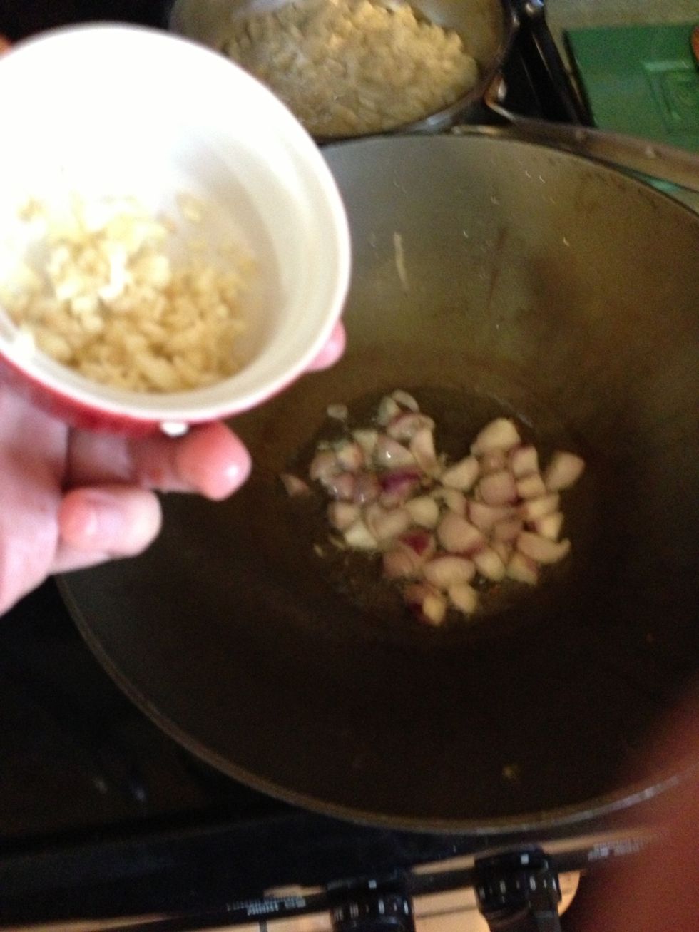 Now that your oil is hot toss in those shallots. Follow it with some garlic.