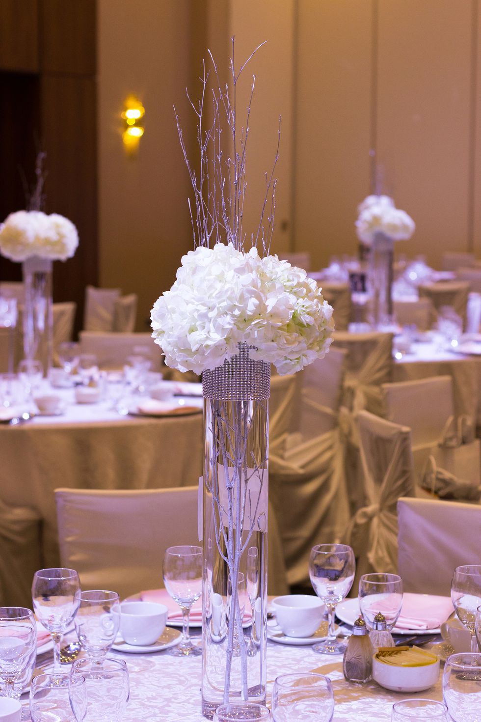 Now that your rhinestone is in place, your vase is ready to be filled. Fill the vase with water, put two silver branches in the vase.