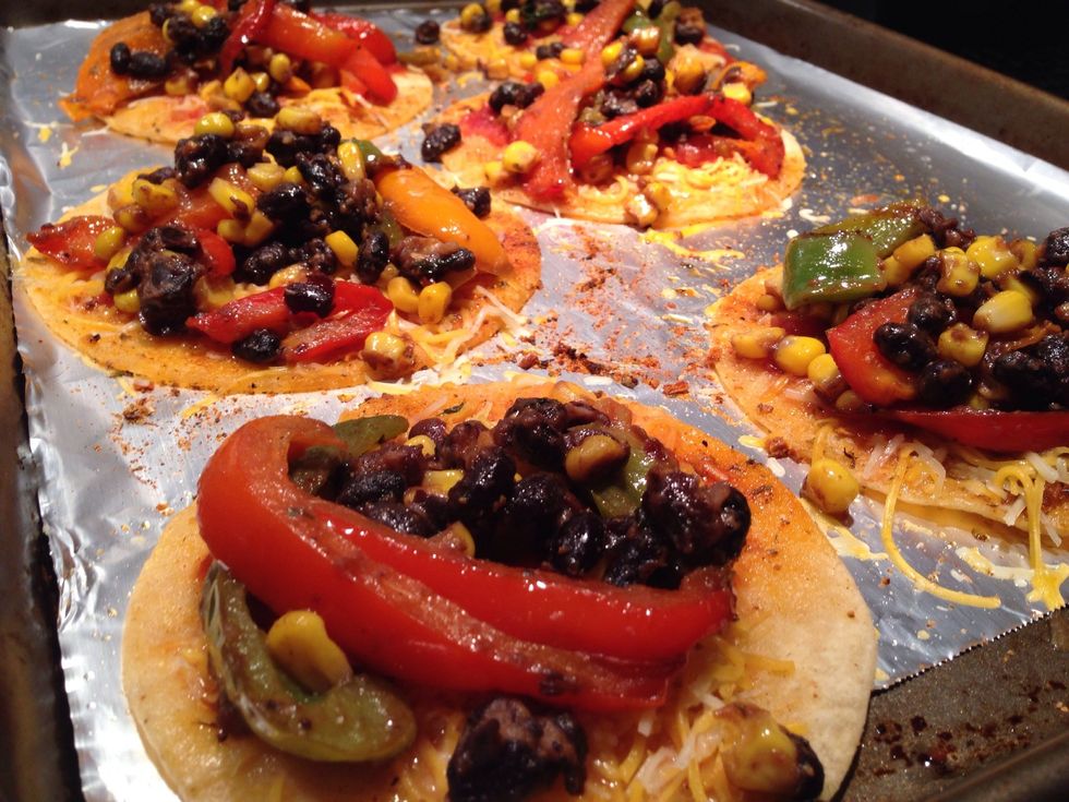 Now that your tortillas have been pre-baked, add spoonfuls of bell pepper mixture to each tortilla. Bake at 350\u00b0F for 5-8 minutes.
