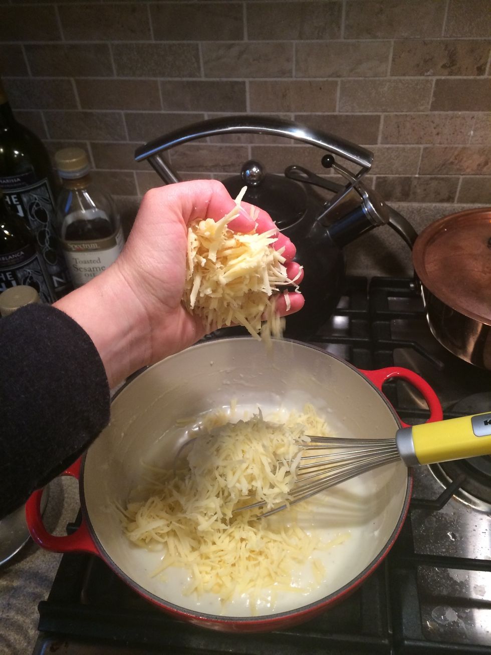 Now the cheese! Save a handful for when you bake it later.