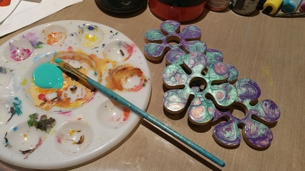 now the finishing touches. I picked both teal and purple paint to finish off the edges. i don't tend to paint the edges as much because the paint makes the objects stick to what they are resting on