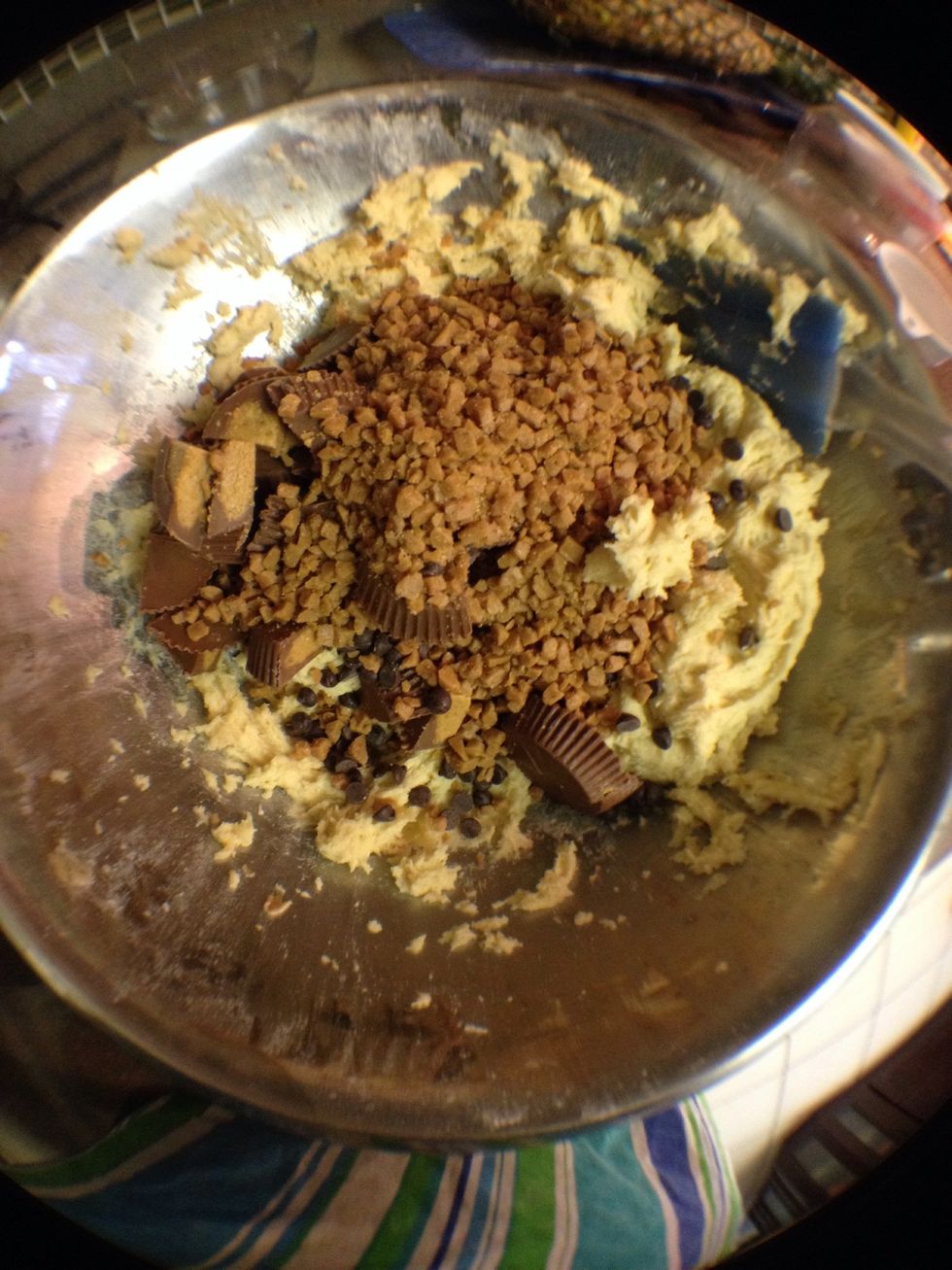 Now the fun bit. Add in your flavourings. You want peanut butter, caramel and chocolate flavours. So I used chopped up Reese's pieces, skor bits, and chocolate chips.