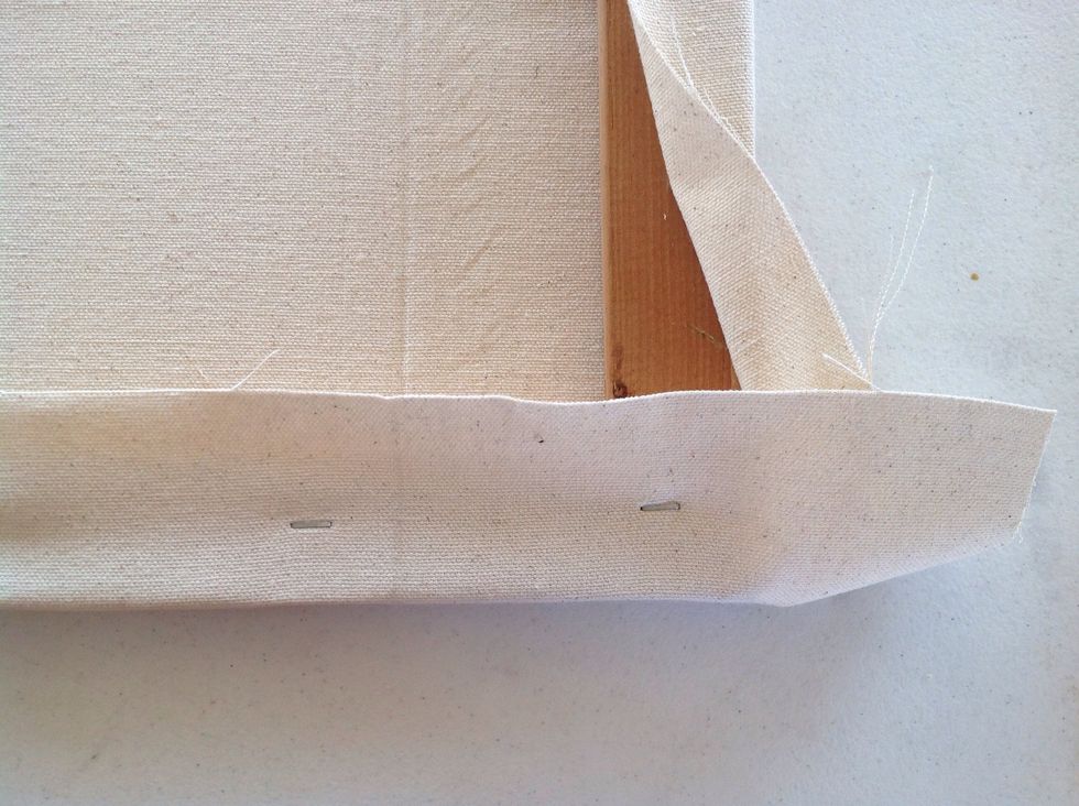 Now the pesky corners. Staple the canvas on one side, I stapled the bottom one here.