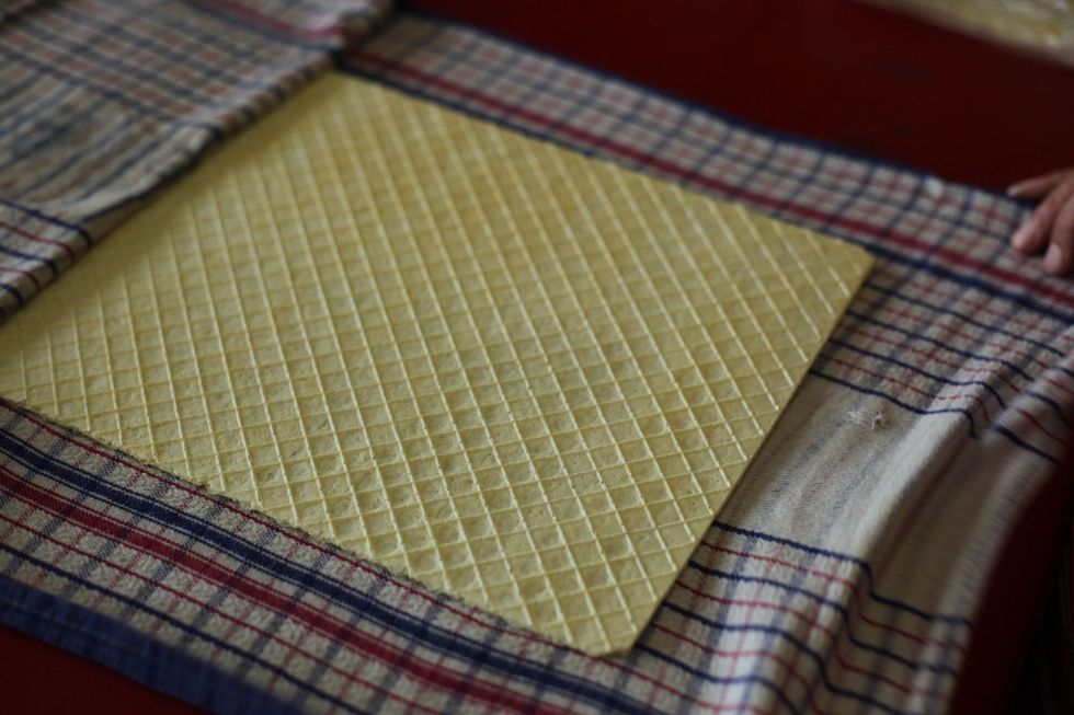 Now the waffle sheets. These might be a little hard to find in your supermarket, but you'll need to find 5 waffle sheets. Lay them to rest in the wet tea towels for 20 minutes or until soft. Fragile!!