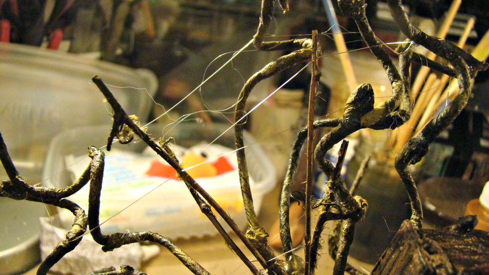 Now those hot glue strands reallly come in handy and the more the better. To make these just dab the hot glue and spread the strands from one side to the other.