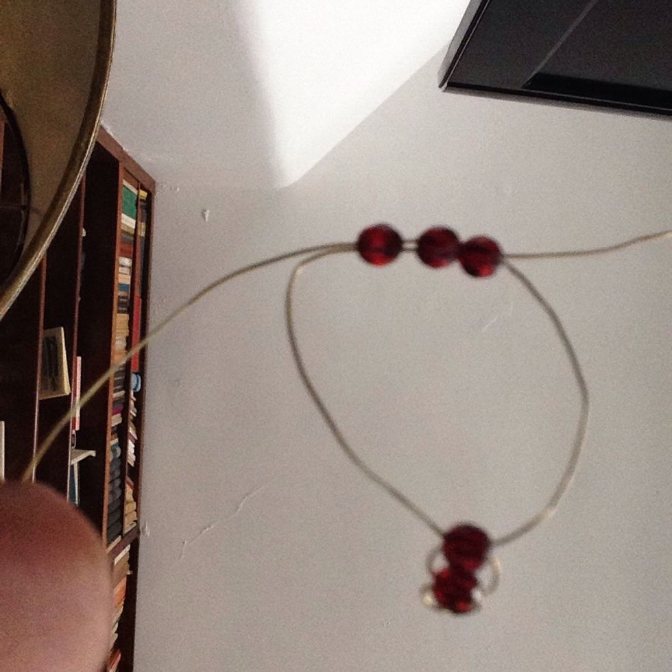 Now,thread three beads using the same thechnique you used for the single beads