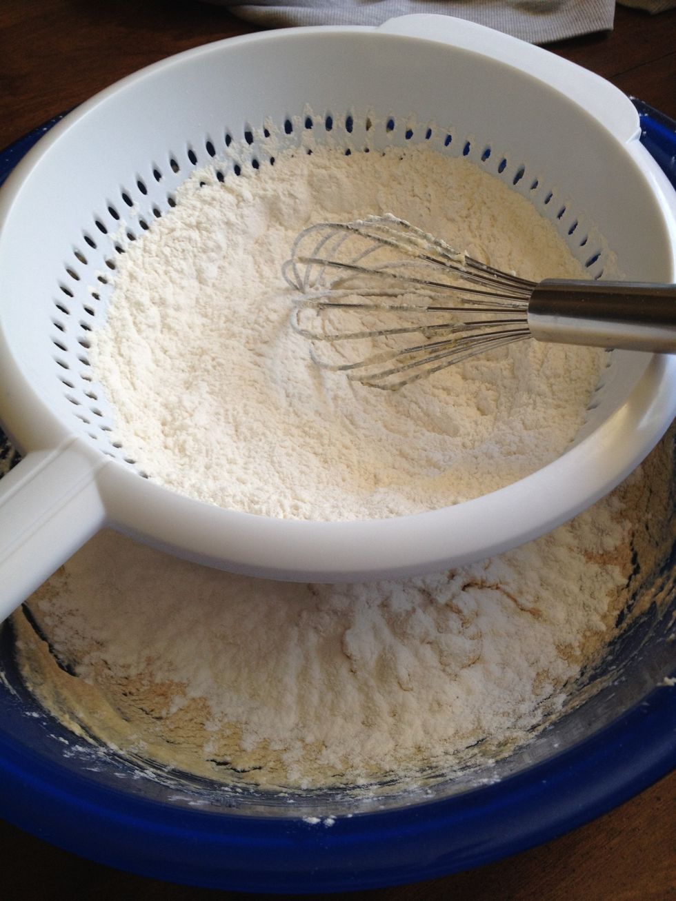 Now time for your dry ingredients. In a sifter over the bowl of your wet ingredients, add flour, baking powder and salt. Gently whisk flour mixture until about 1/3 has fallen into wet mixture.