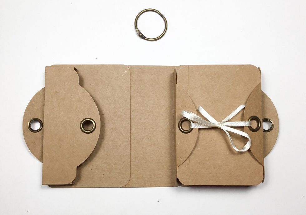 Now time to assemble. Glue mini album to the inside of the cover on the right side and the pocket on the left side as shown. The base of the mini album is now complete.