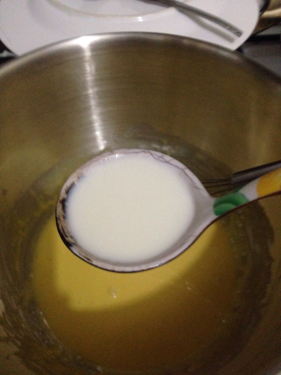 Now time to temper the egg mixture. Add slowly 2 laddleful of hot milk to egg mixture while whisking the egg constantly