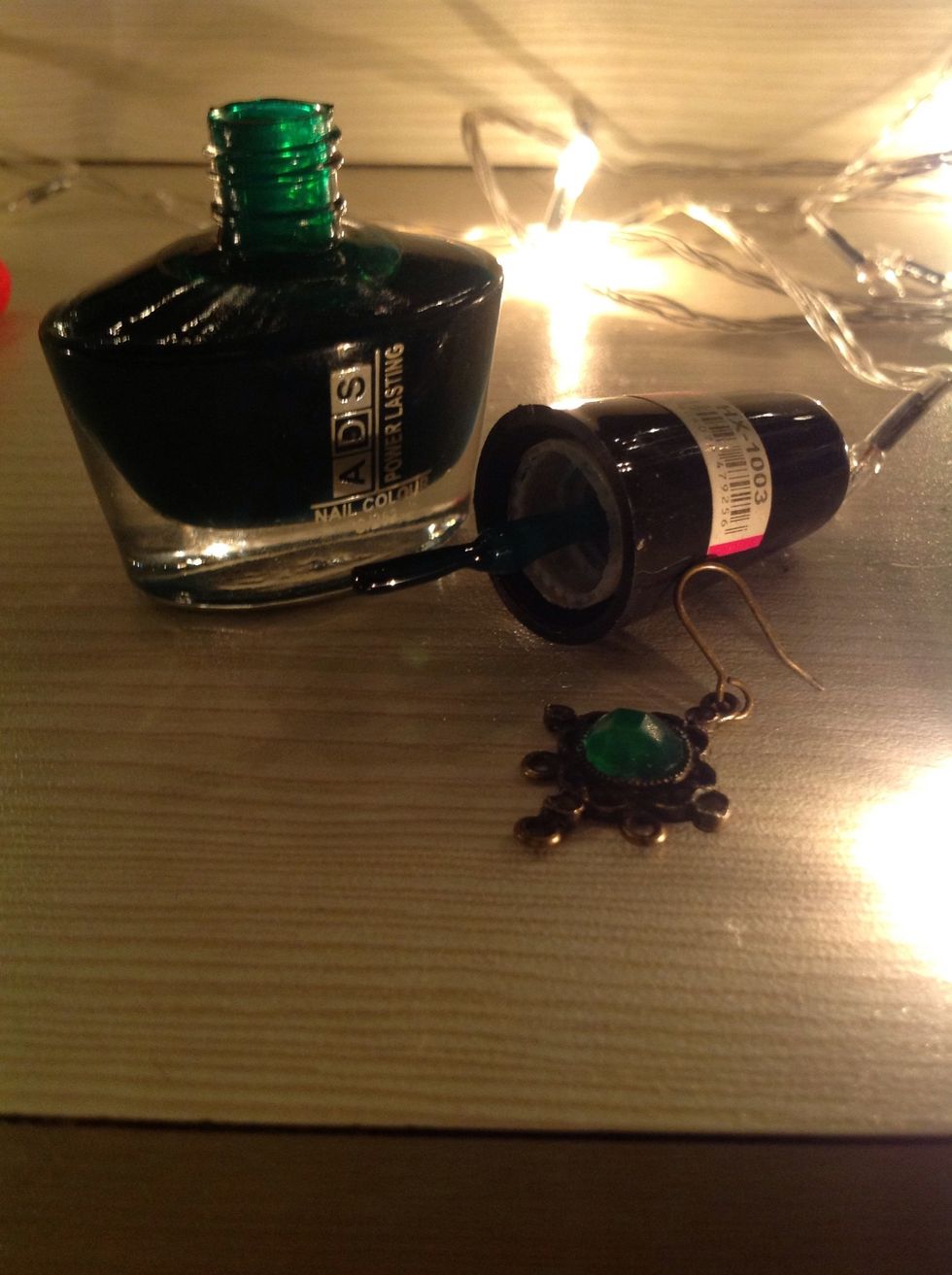 Now, to add some colour to my earrings, I used an emerald green nail polish. What you have to do here is, simply paint the whole jewel and make sure it looks even.