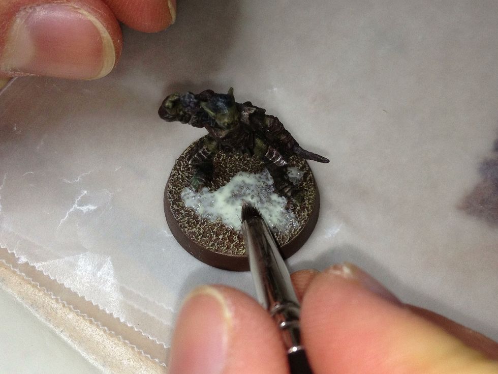 Now to add some detail! Take some carpenter's glue and paint it in one or two patches onto the now painted sand. The size of the patches depends on your personal preference.