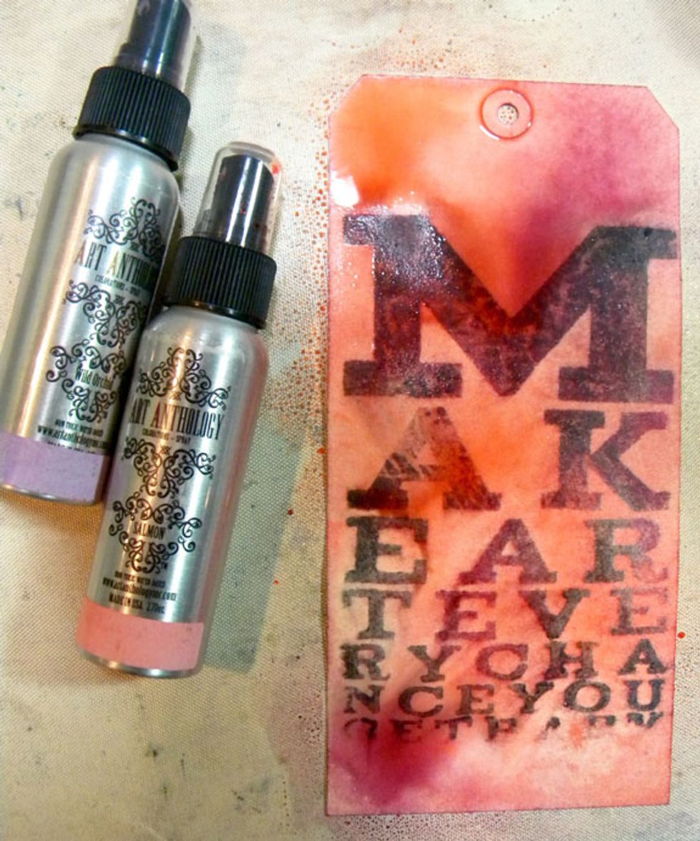 Now to embellish the tags. Apply Salmon and Wild Orchid Colorations Sprays. The Velvets will resist the sprays. I rolled a paper towel roll over it to soak up excess spray.