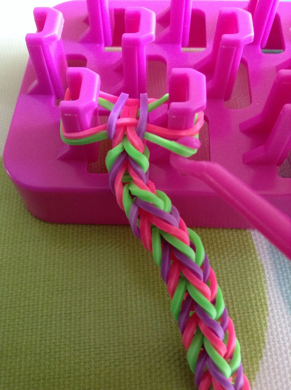 Now, to finish off, take the bottom band, without putting on another one on top and loop it over like normal.