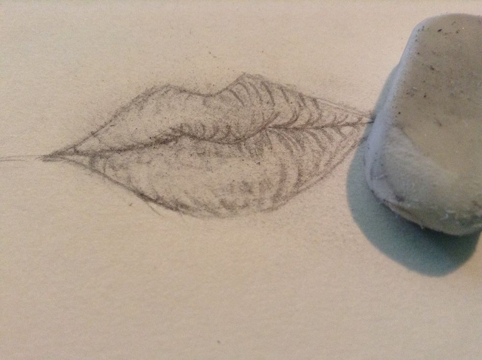 now, to highlight! so just erase one corner of the whole lip a tiny bit. after that ad some lines that might have been erased too much