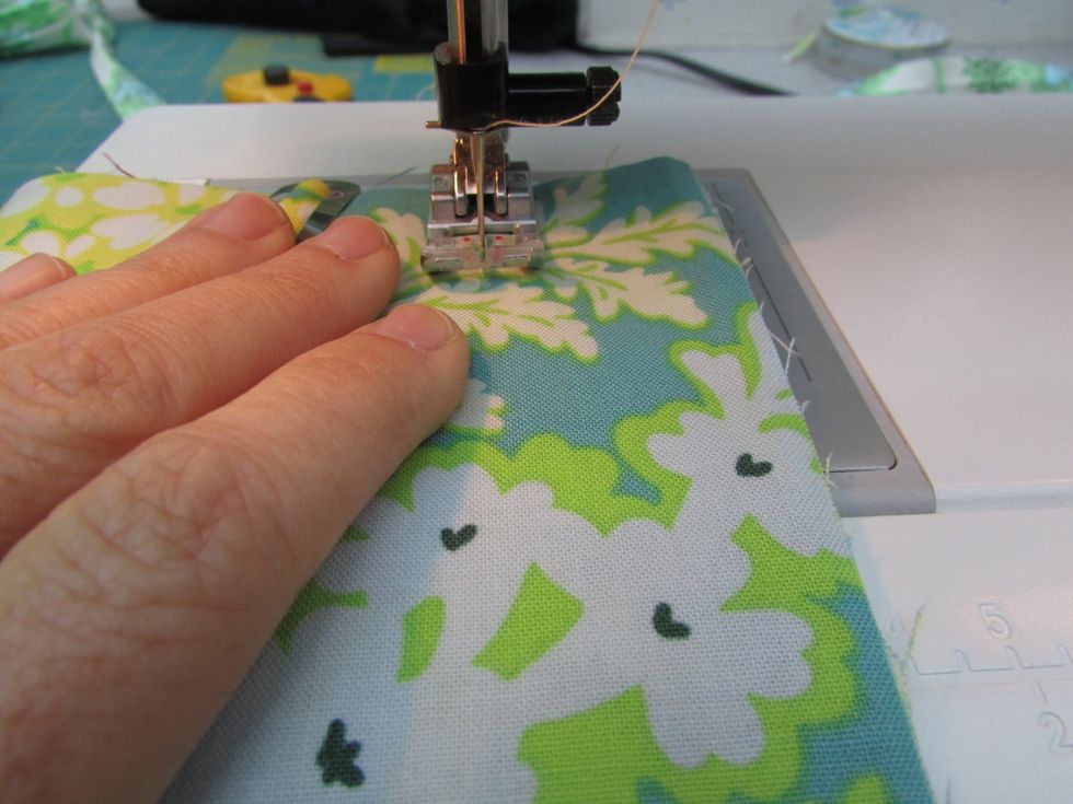 Now to stitch the individual pockets for your needles. Start at the bottom right corner, stitch a straight line 1 1/2" from the side. I use guide lines on my machine, but you can draw chalk lines.
