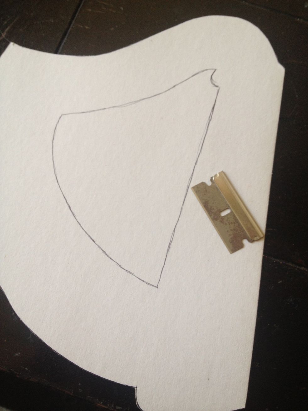 now trace the center from your template and cut using a razor blade. you do not want to fold and use scissors because on most papers, especially glitter paper, the fold shows on the front.