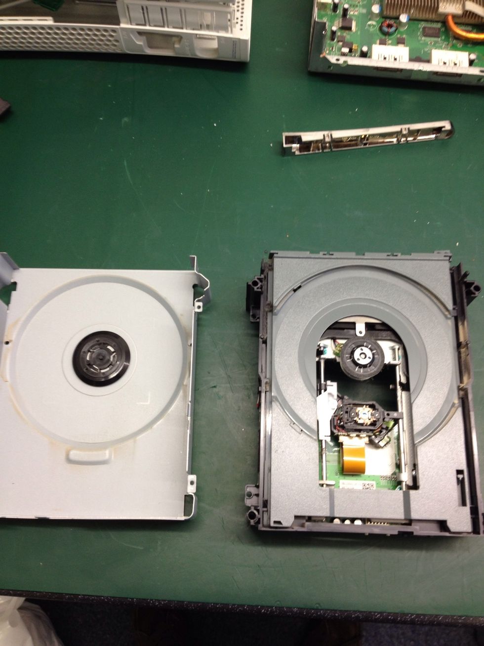 Now turn the drive back over and remove the too case, revealing the laser and drawer. NOTE!! Do not touch the laser with ANYTHING!