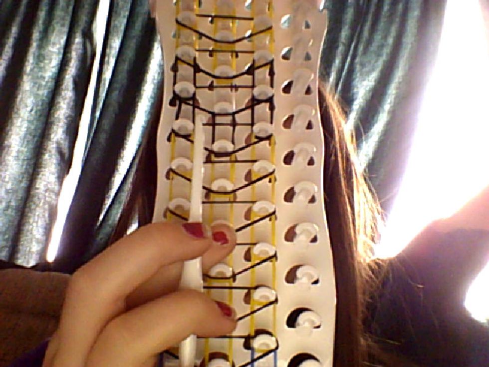 Now turn the loom around and grab your hook.