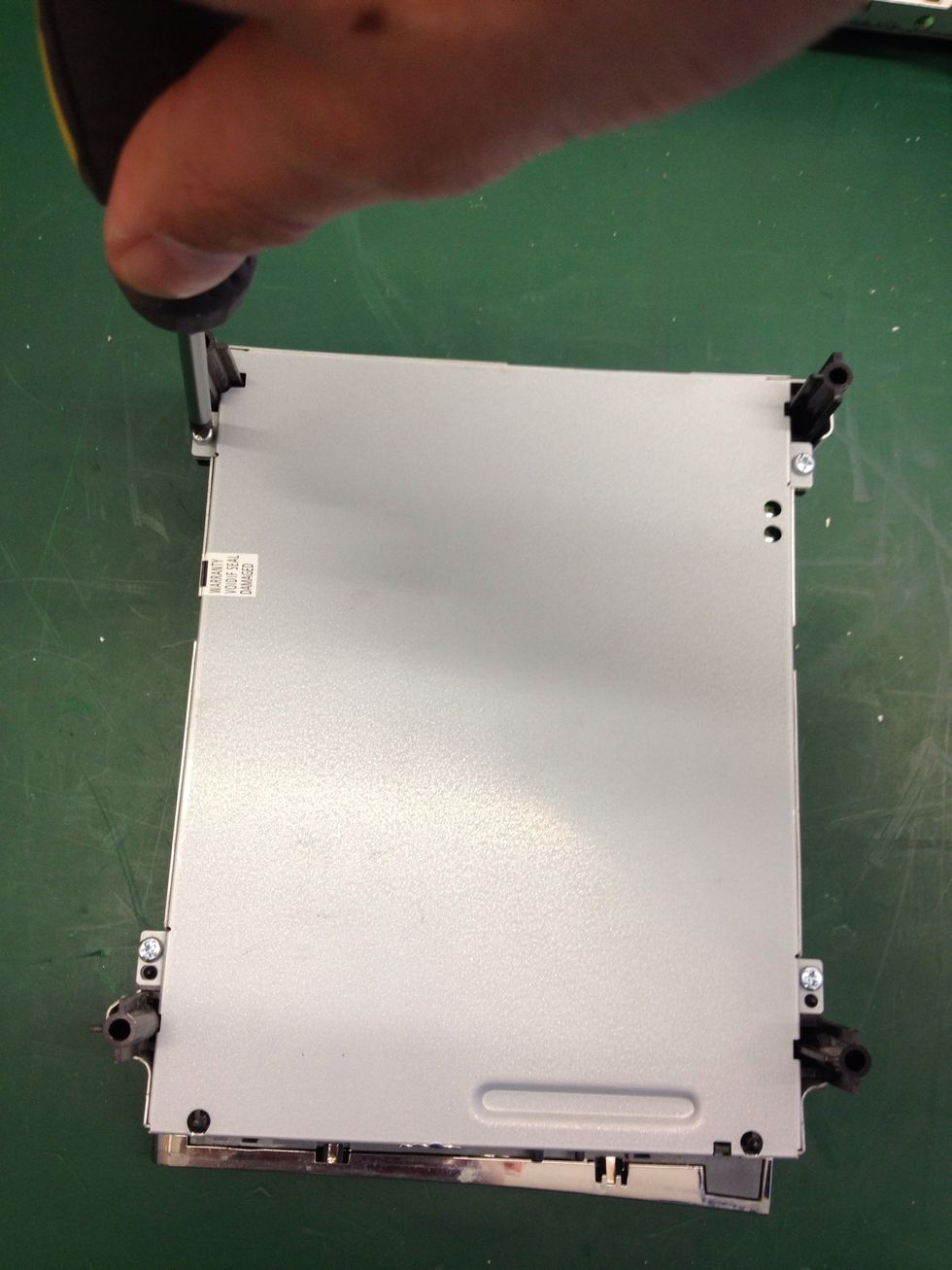 Now unscrew each of the four screws with your crosshead screwdriver.