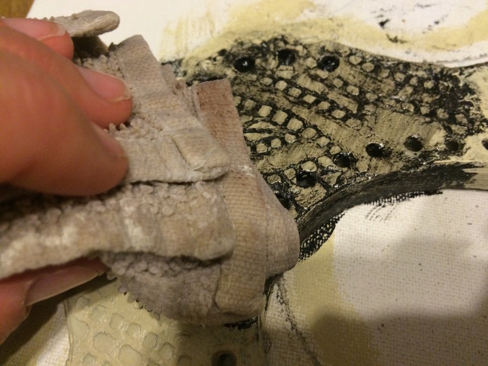 Now use a damp rag to lightly wipe away excess paint. Follow up with a paper towel. If you rub to harshly you will lose some of the texture.