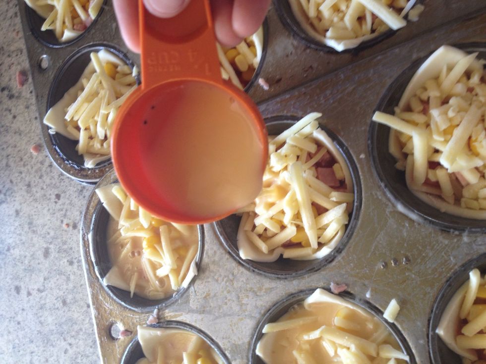 Now use a small cup (I use a quarter cup) to pour the egg mixture over the ingredients. Use just enough to almost cover the ingredients (remember it will rise).