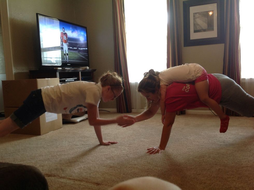 Now use a teen and play plank 5. We could do 20 before the 4 year old slid off my back. You are basically in plank and touching hands across. Try to keep your body still!