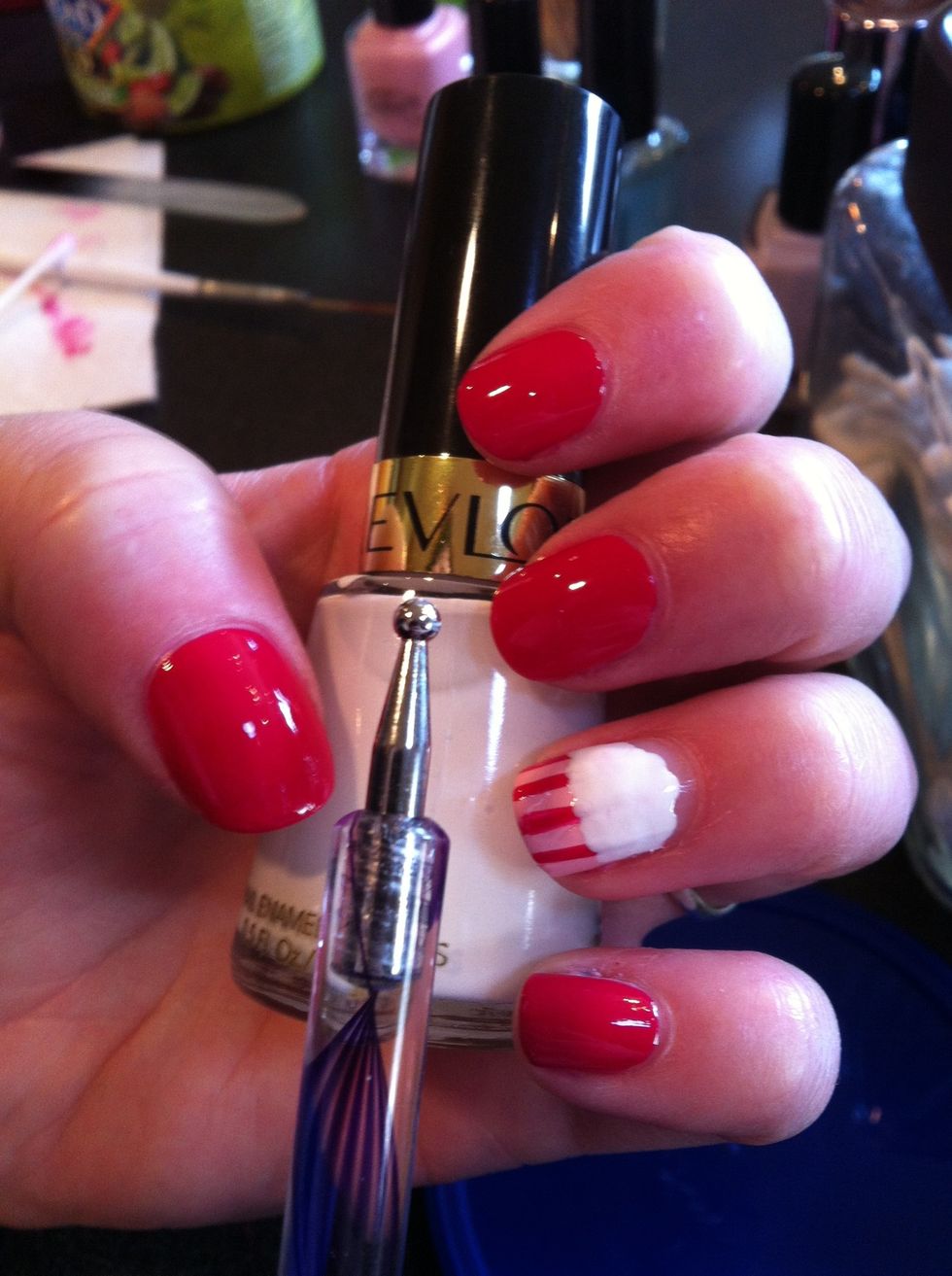 Now use the dotting tool to make the frosting. This should cover part of your striped bit and extend almost to the top if your nail, but do leave some space.