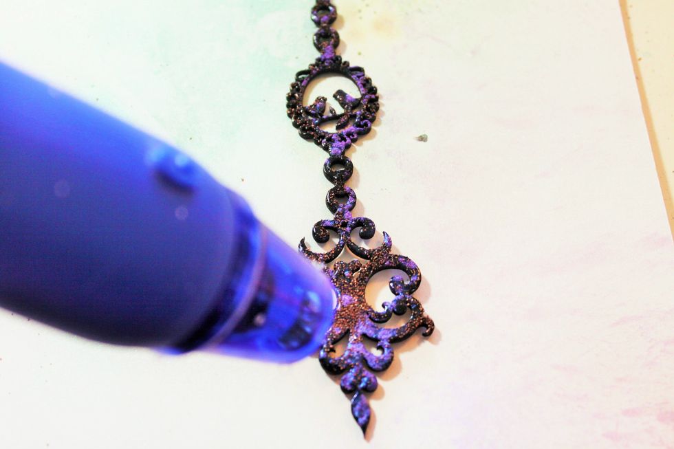 Now, use the embossing heat gun to melt the embossing powders. This will cause the paint to bubble up a bit in places (I pushed the bubbles down). This will cause the distressed look.