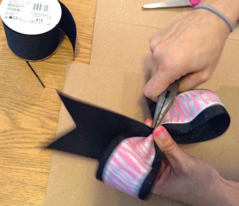 Now use the pliers to secure the zip tie as tightly as possible so the bow does not move.