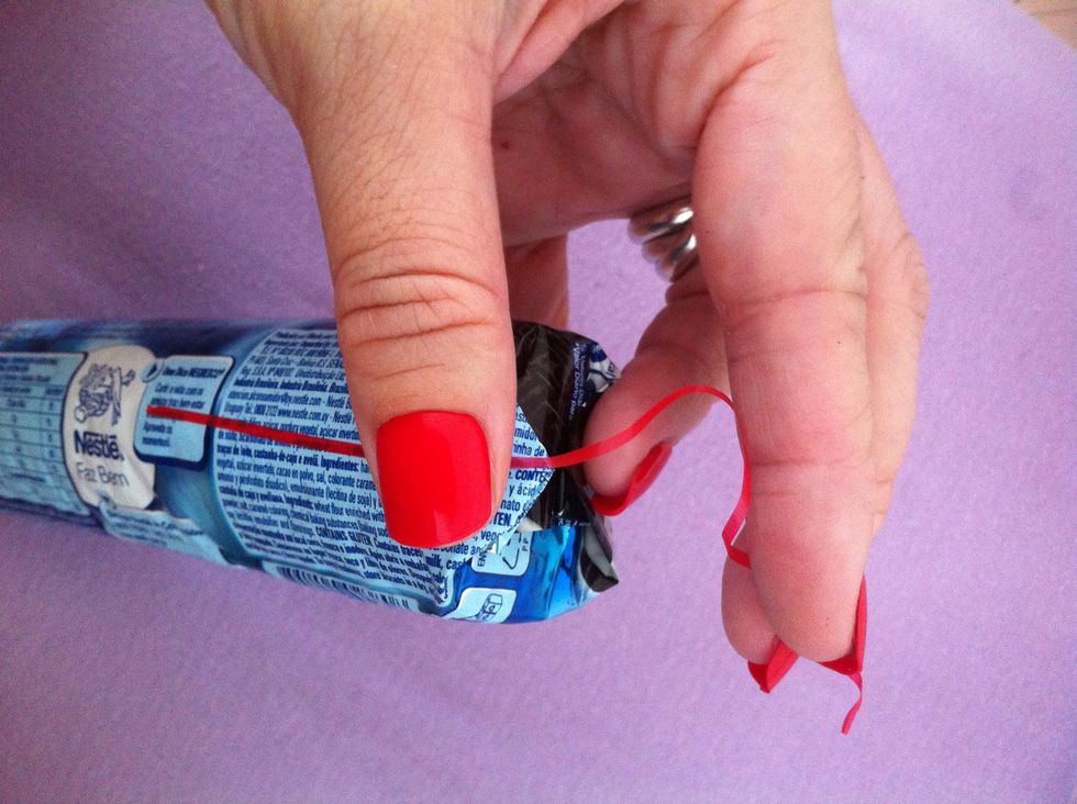 Now use the ribbon to get the folds together - hey you can use any kind of tape here... This red one is practical in my opinion.