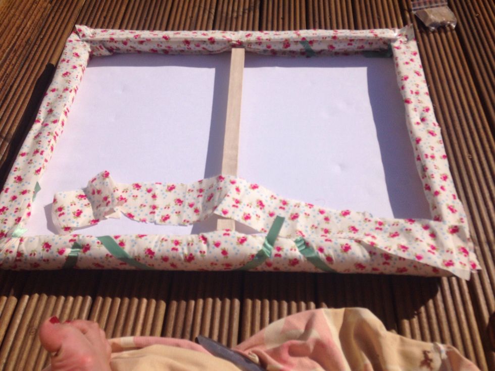 Now use the spare fabric to cover up the staples and ribbon ends on the back.