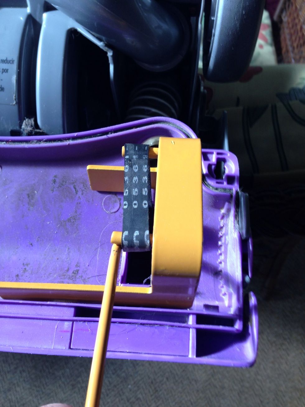 Now use the tool to stretch the belt to the second prong. You might need someone to hold the vacuum. This belt is very tight.