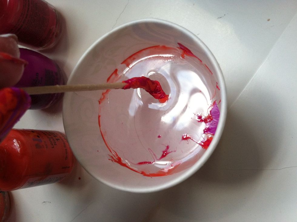 Now use the toothpick to pick up the dry polish off of the water.