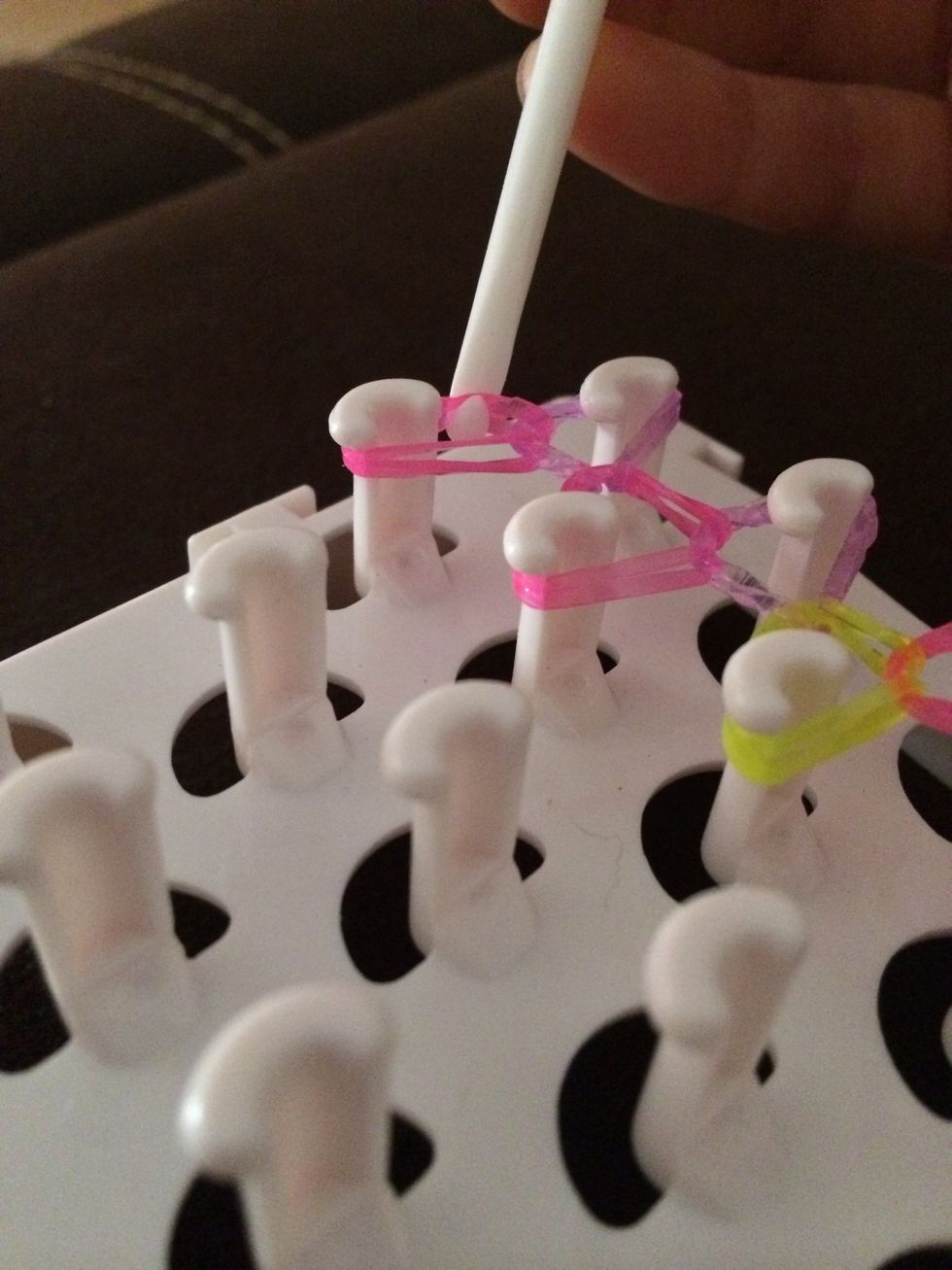 Now use your pick and grab all of the pink elastic band