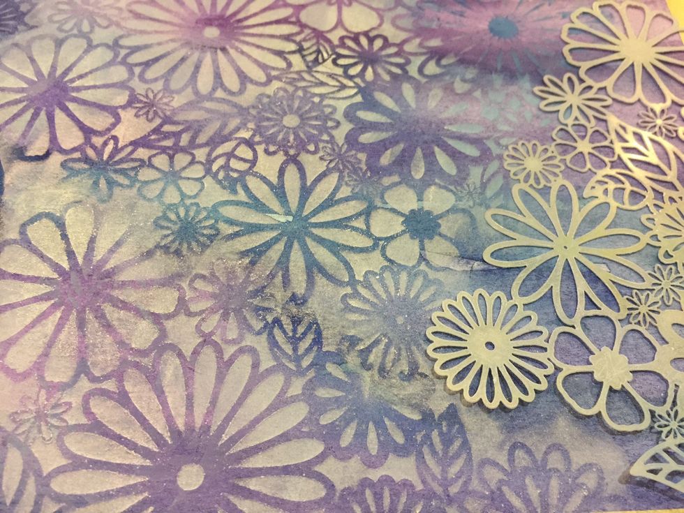 Now using a lighter shade than the colour you are working on, hold the stencil and sponge gently over the watercolor area.