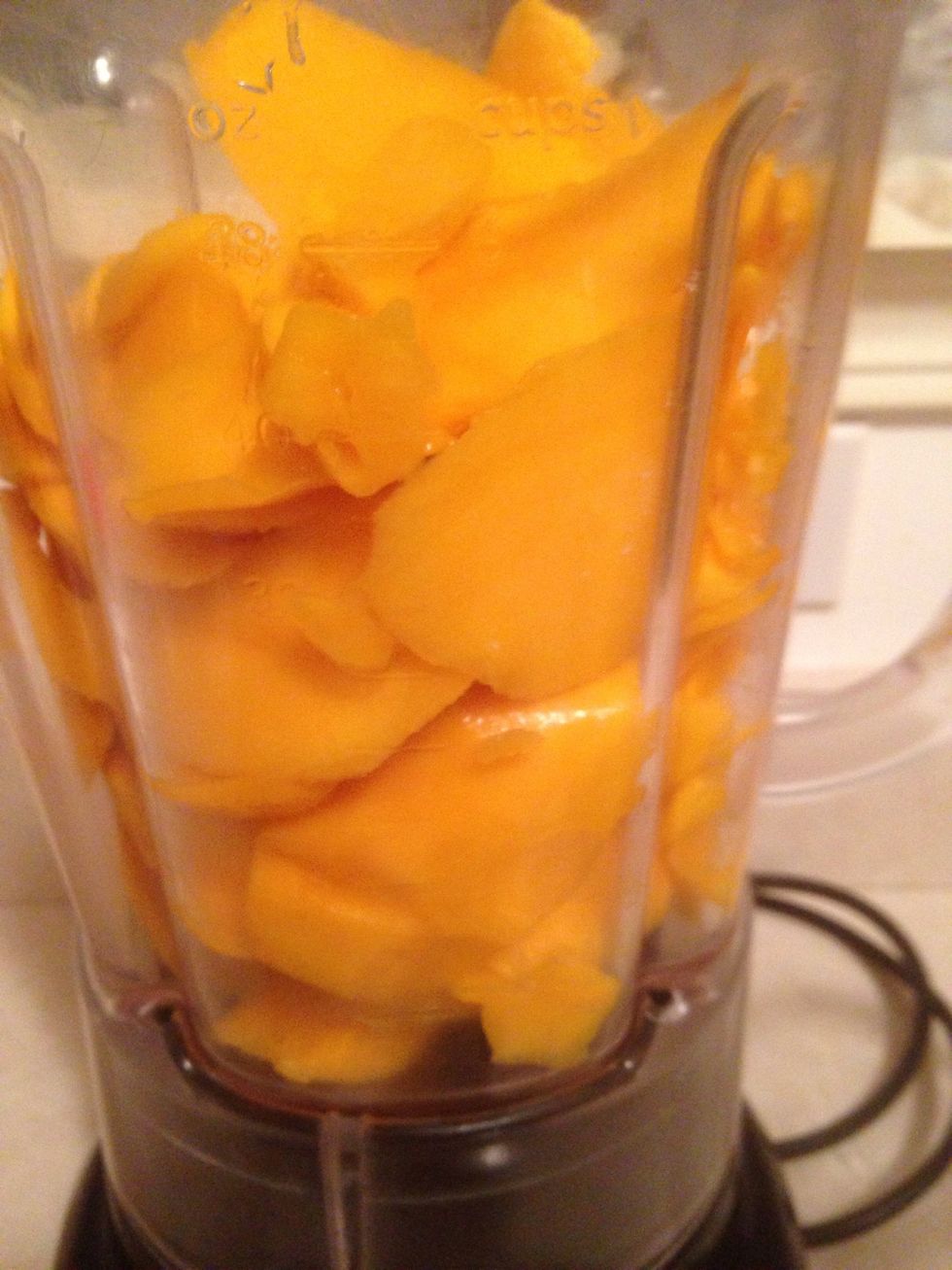 Now using knife cut thin slices of mango and put them in blender