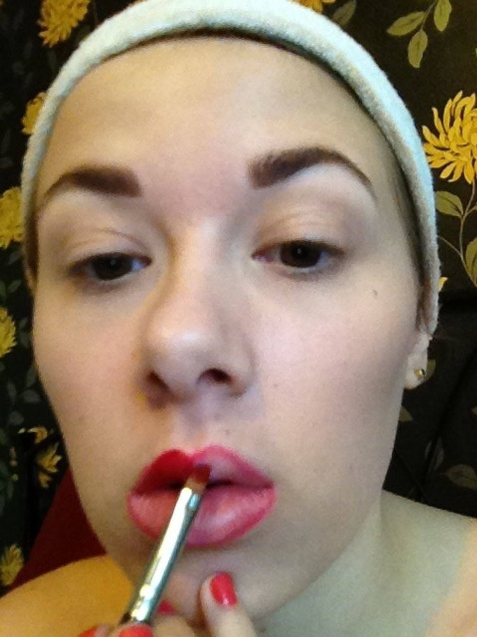 Now using you lip brush apply your red lipstick evenly