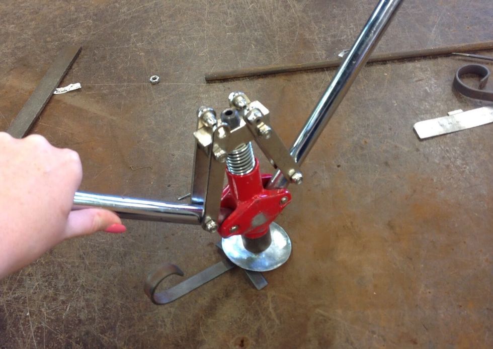 Now using you pop rivet, get all the things you have created (feet, scroll, wax catcher) and align them all together. Once this is done pop rivet them together.