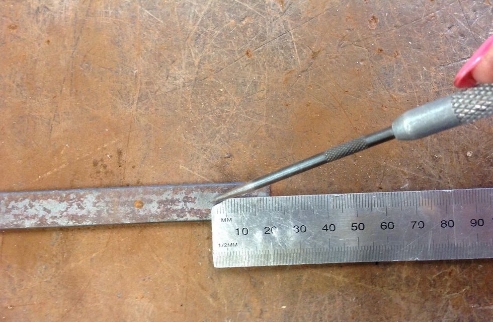 Now using your ruler and scribe, measure 1.5 cm from the end of the scroll. Then using your centre punch, indent a mark in the centre of that line.