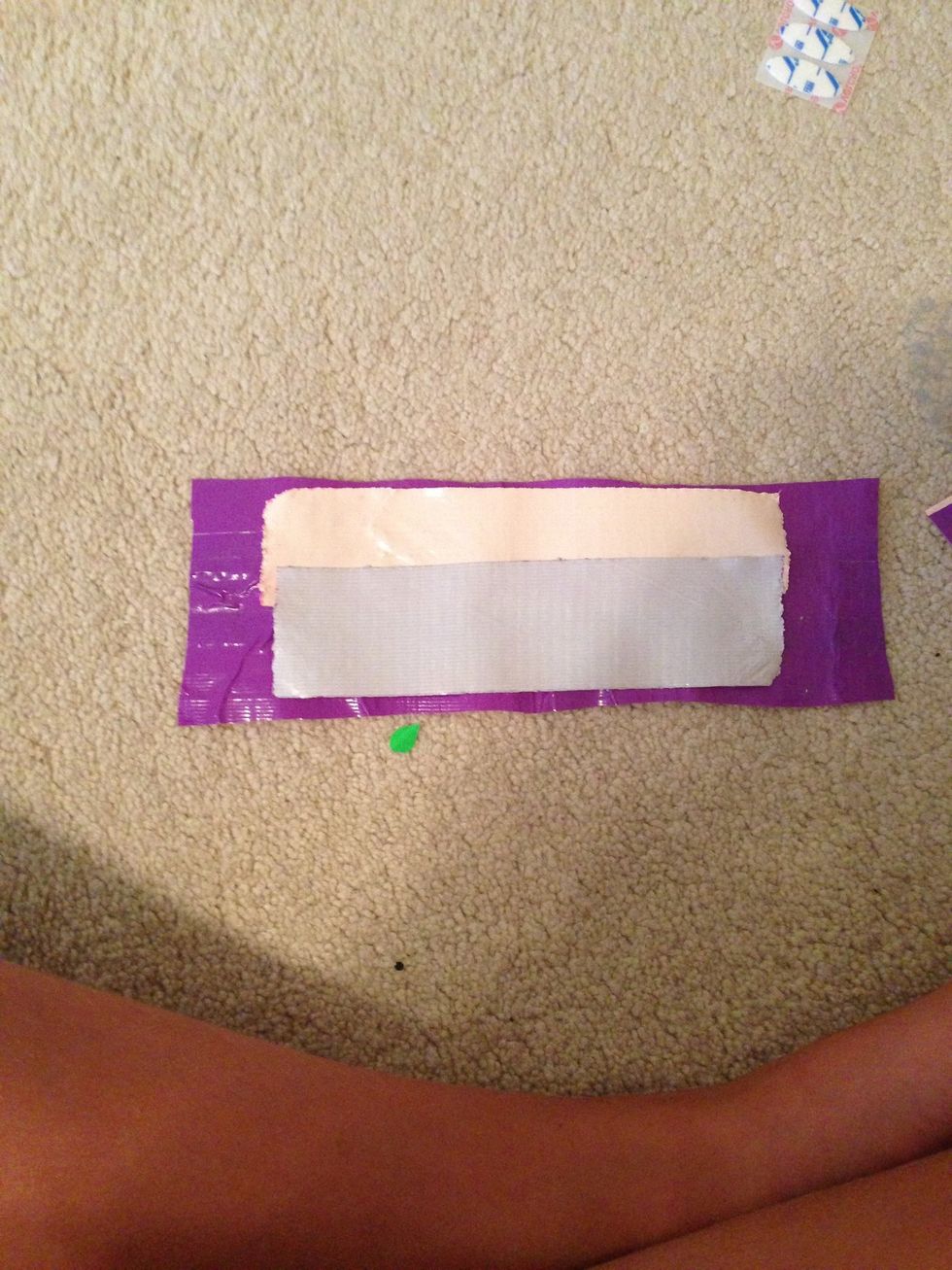 Now we are going to make a pocket, take 2 strips of duck tape and place it on top of your double sided strip