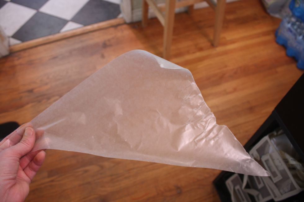 Now we are going to make an icing bag- cut a square piece of parchment in half so you have a triangle (or you could buy pre made icing bags at the craft store)