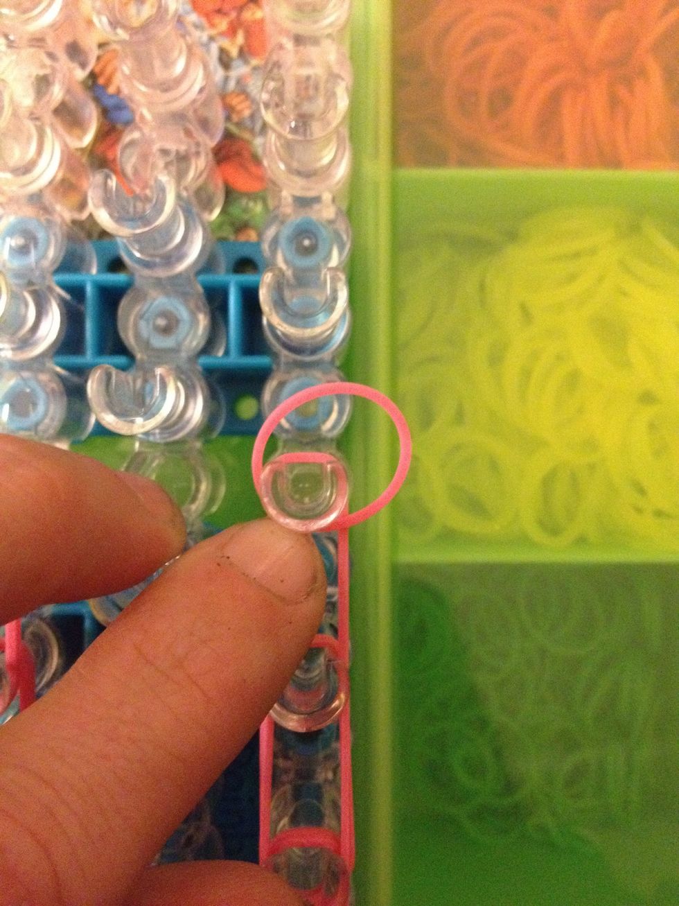 Now we are going to place the two capping bands. Wrap a rubber and around the last peg 3 times.