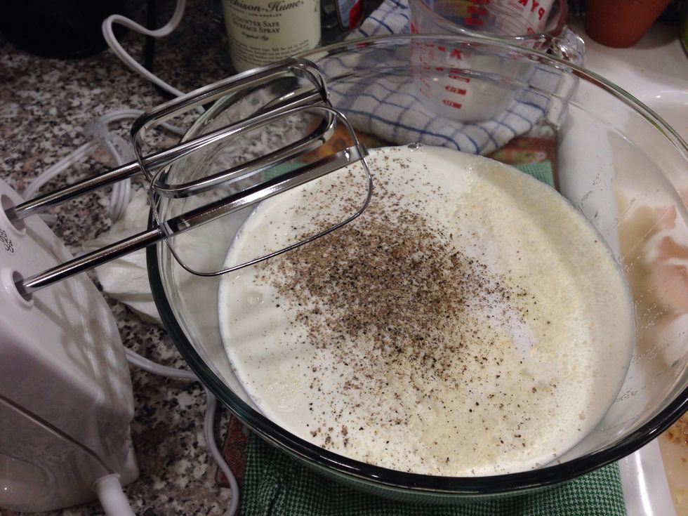 Now we can crack the eggs into a large bowl along with the cream, grated Parmesan, salt and pepper. Beat it with a whisk or hand mixer until everything is nicely combined!
