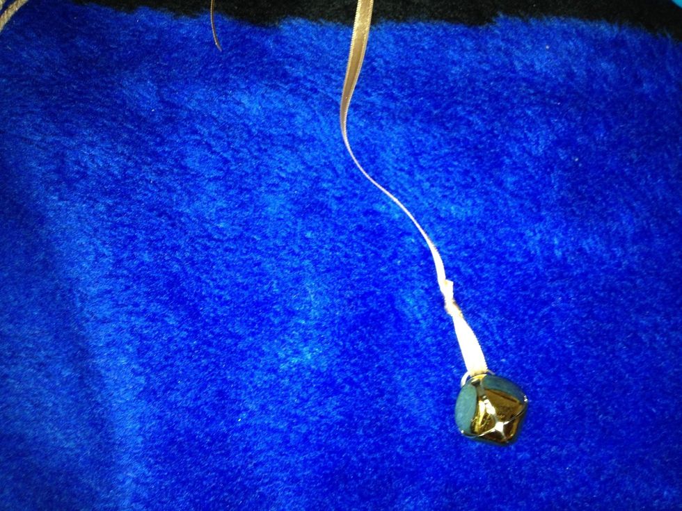 Now we going to put the little bell into. Cut the ribbon in three same size parts (for three bells). Tie a knot putting into the little bell.