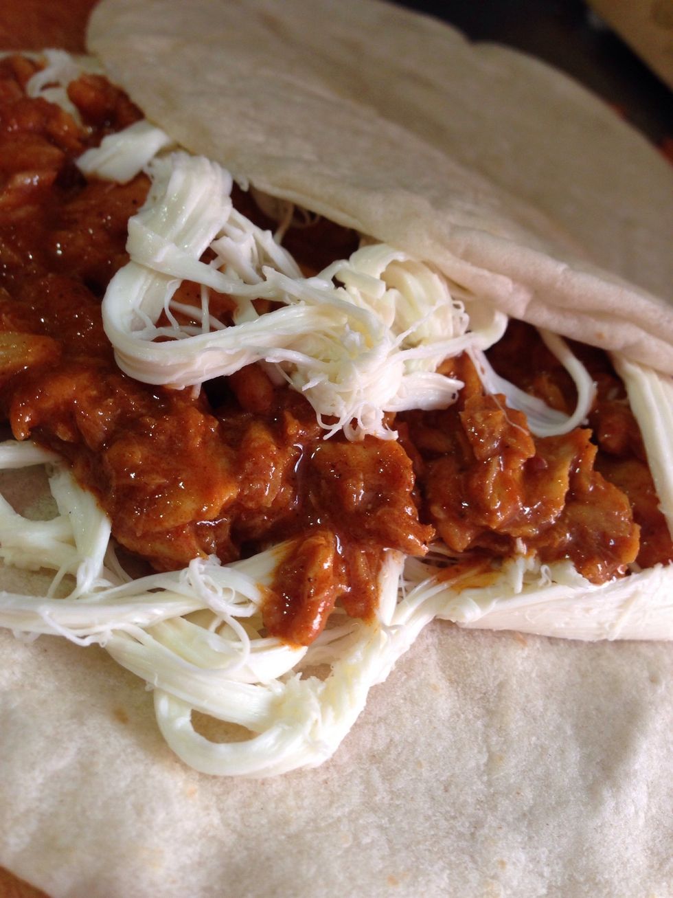 Now we have all ingredients ready, we start building up our dish. Get a wheat tortilla, on top out some cheese, on top of the cheese put the fish, and more cheese \ud83d\ude4a