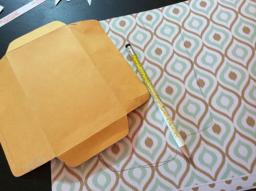 Now we'll craft the envelope keepsake... Trace a small policy envelope onto patterned paper.