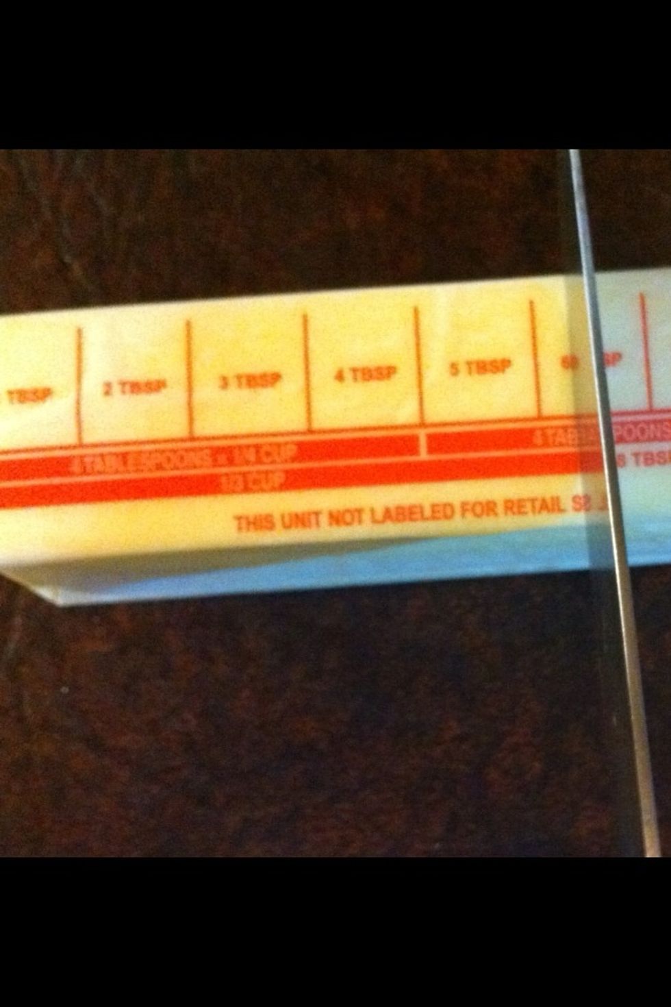 Now we need 1/3 cup butter. I only use real butter. See on the stick it tells you how much a 1/3 cup is? Cut right there. Save the rest of the stick to butter later.